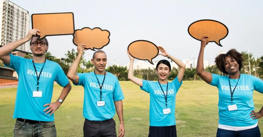 a group of people holding up speech bubbles