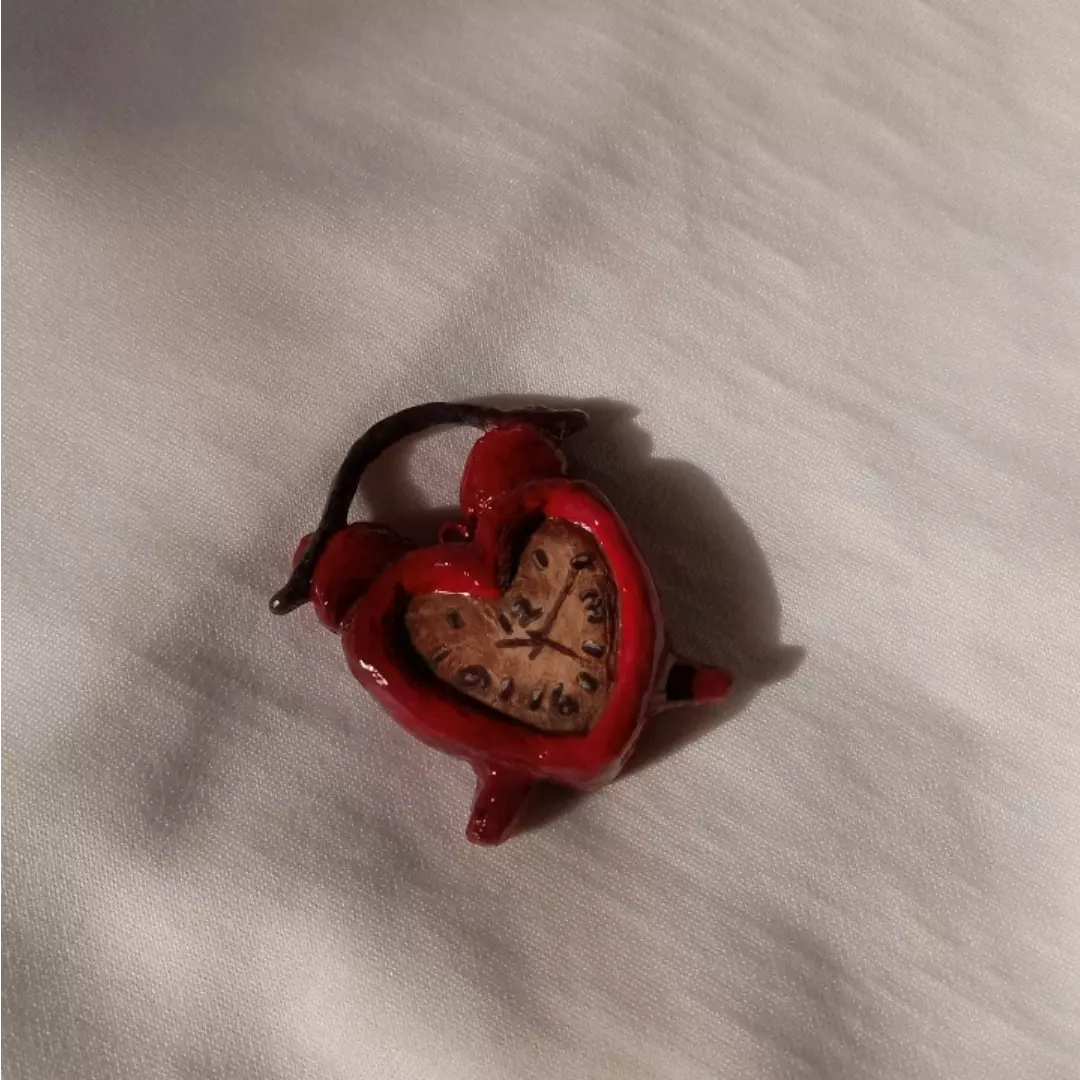 a red heart shaped clock