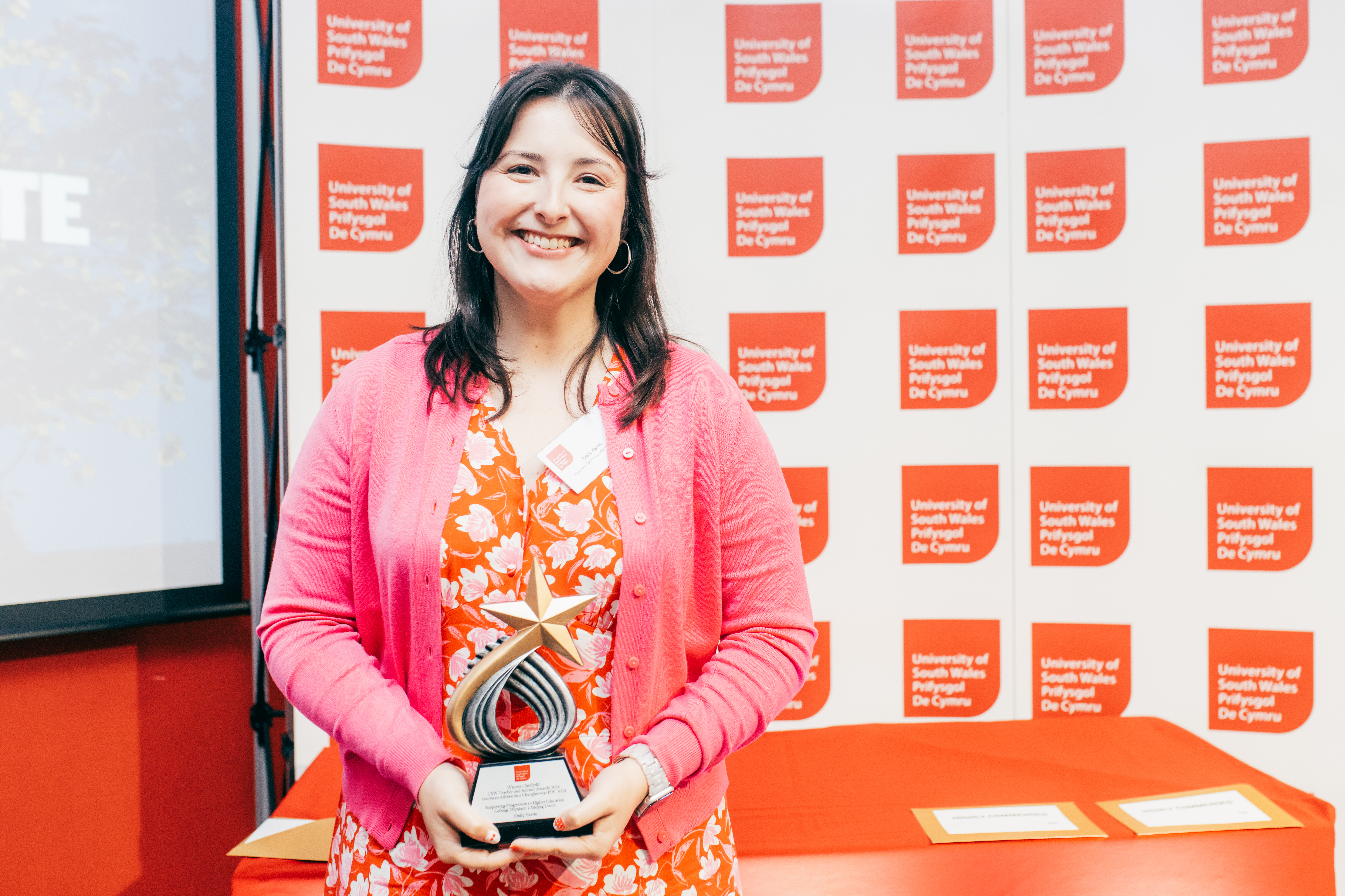 a woman holding a trophy