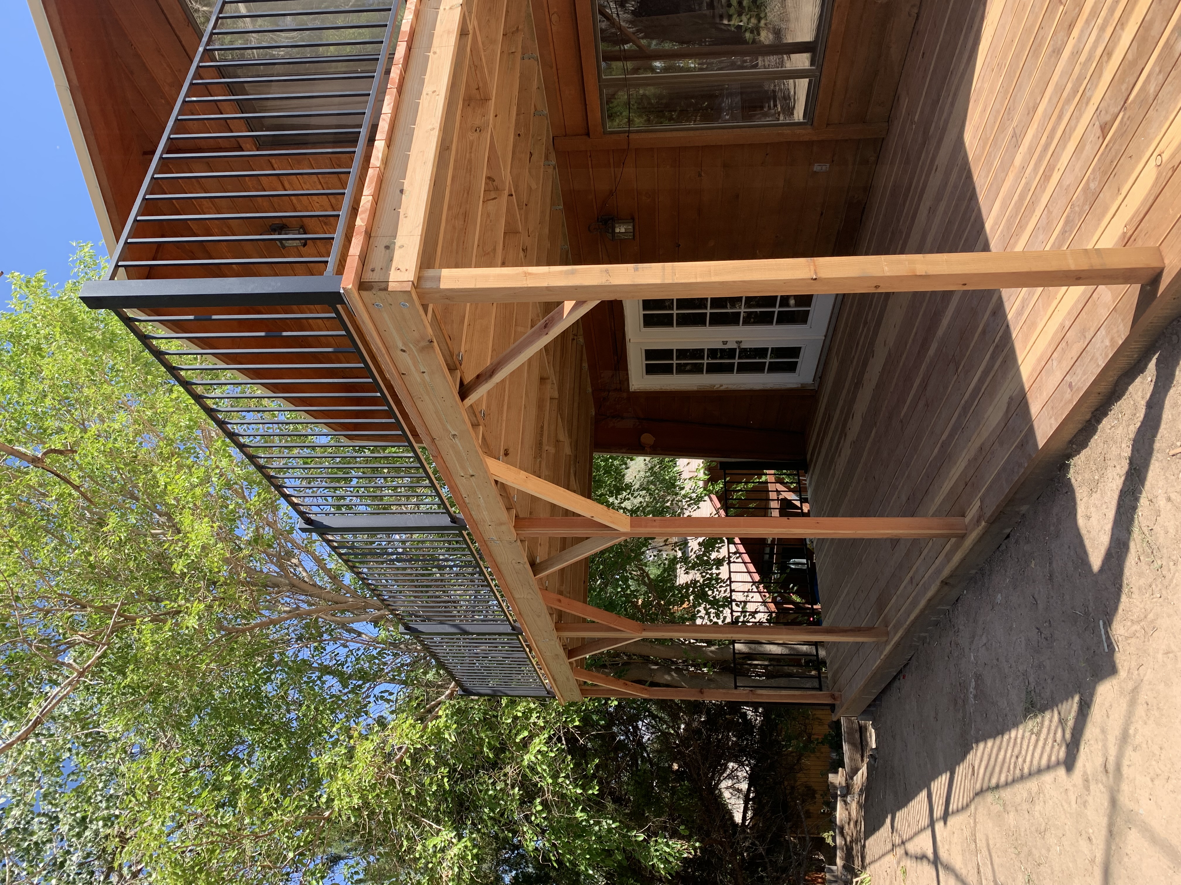 a deck of a house with a metal railing