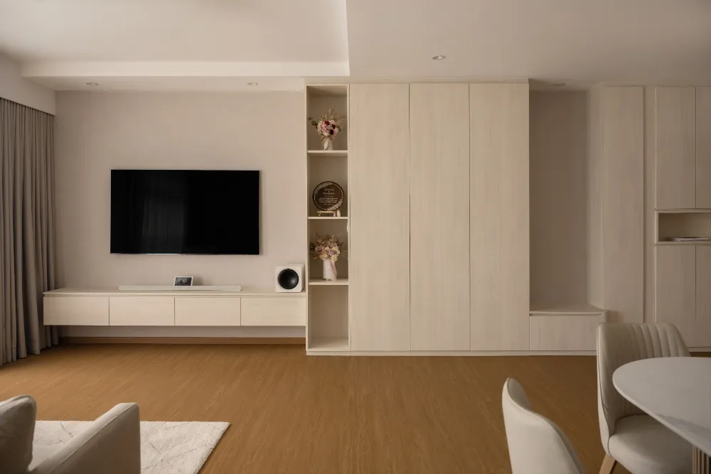 a room with a tv and a wood floor