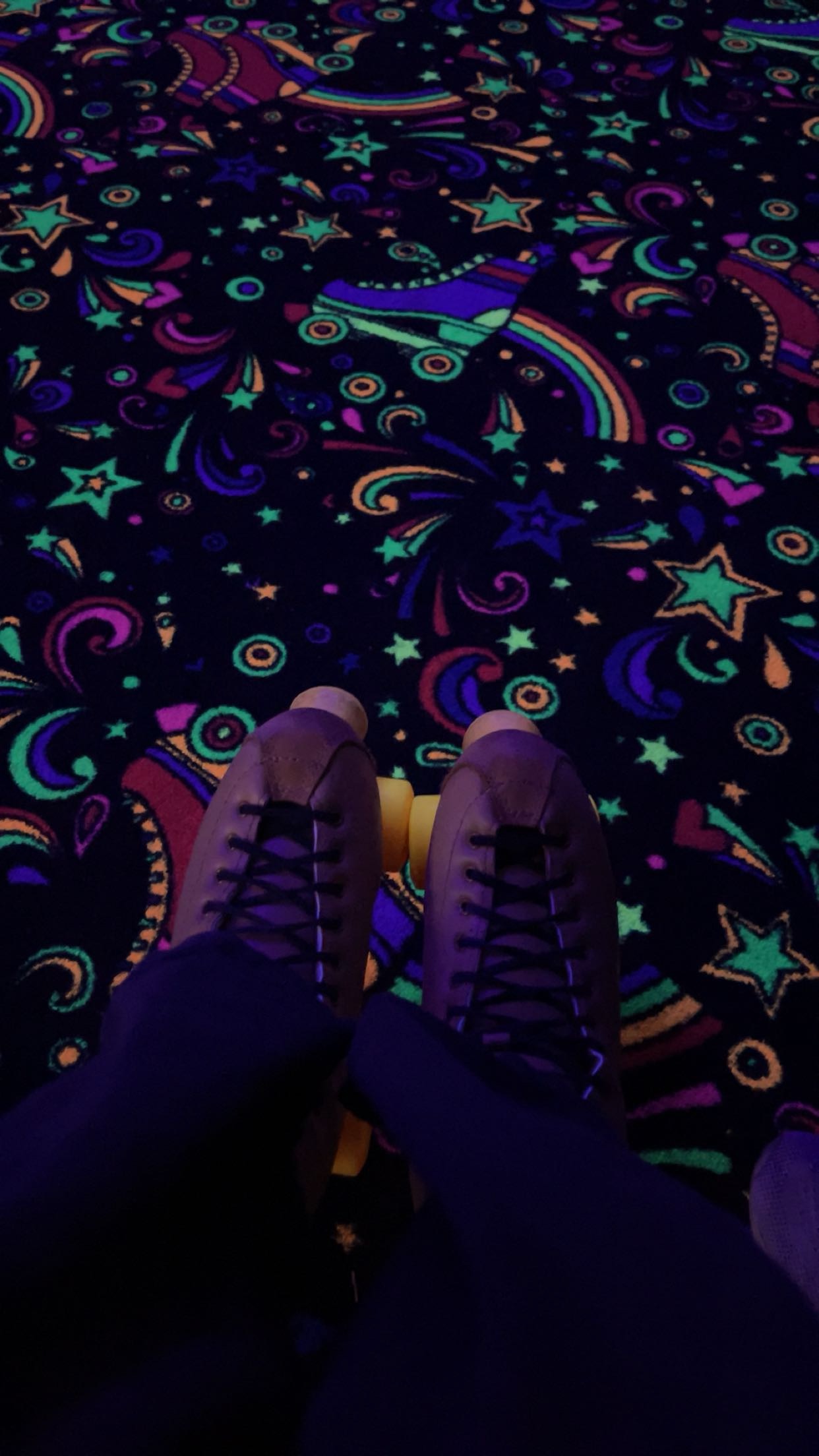 a person's feet on a carpet with colorful patterns