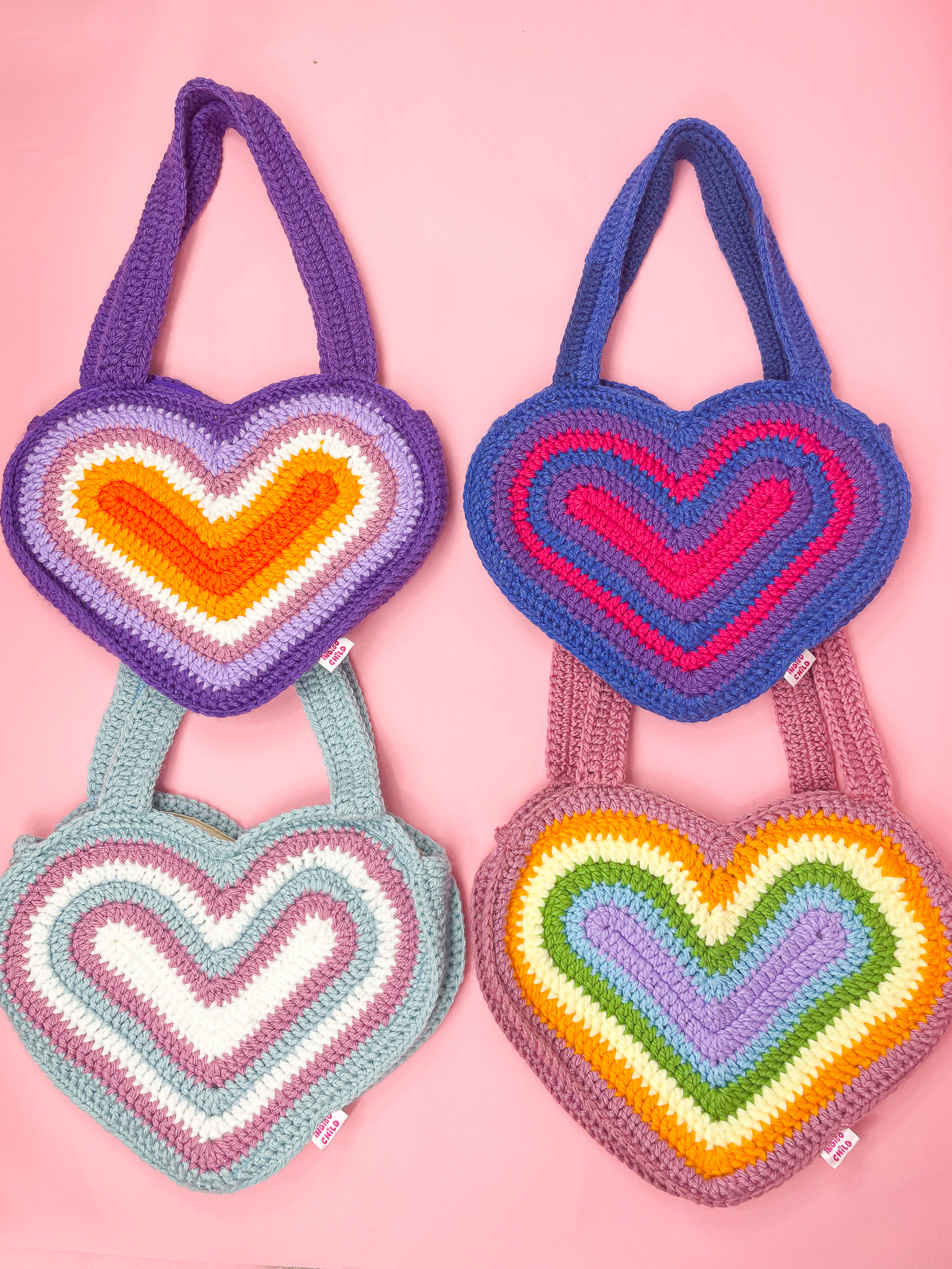 a group of colorful knitted bags