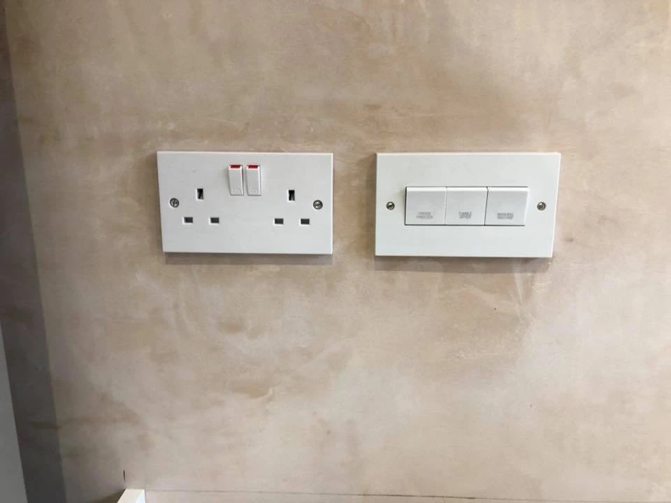 a white electrical outlet on a wall