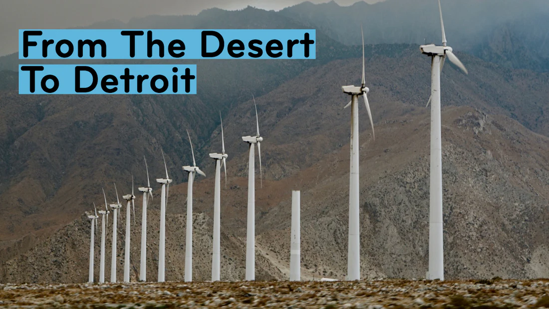 a row of wind turbines in a desert