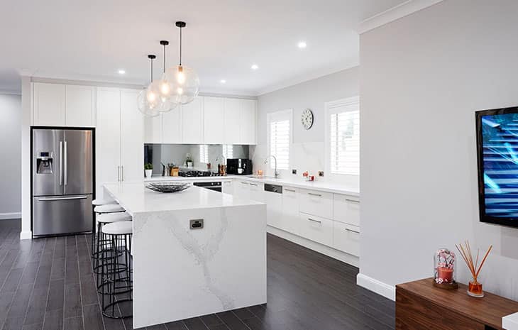 a kitchen with white cabinets and a black stove