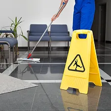 a person mopping the floor