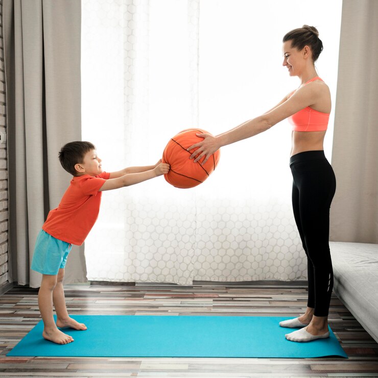 a woman and a child playing with a ball