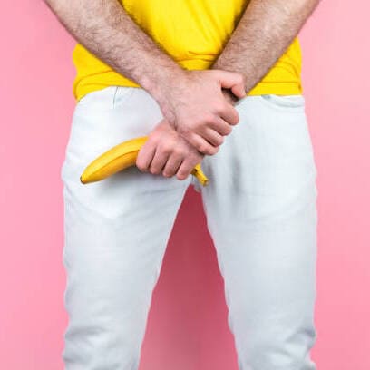 a man holding a banana in his pants