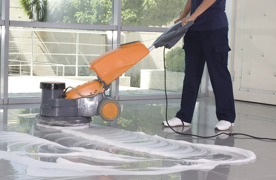 a person using a machine to clean the floor