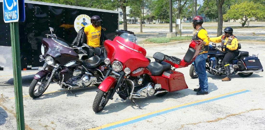 a man standing next to a red motorcycle