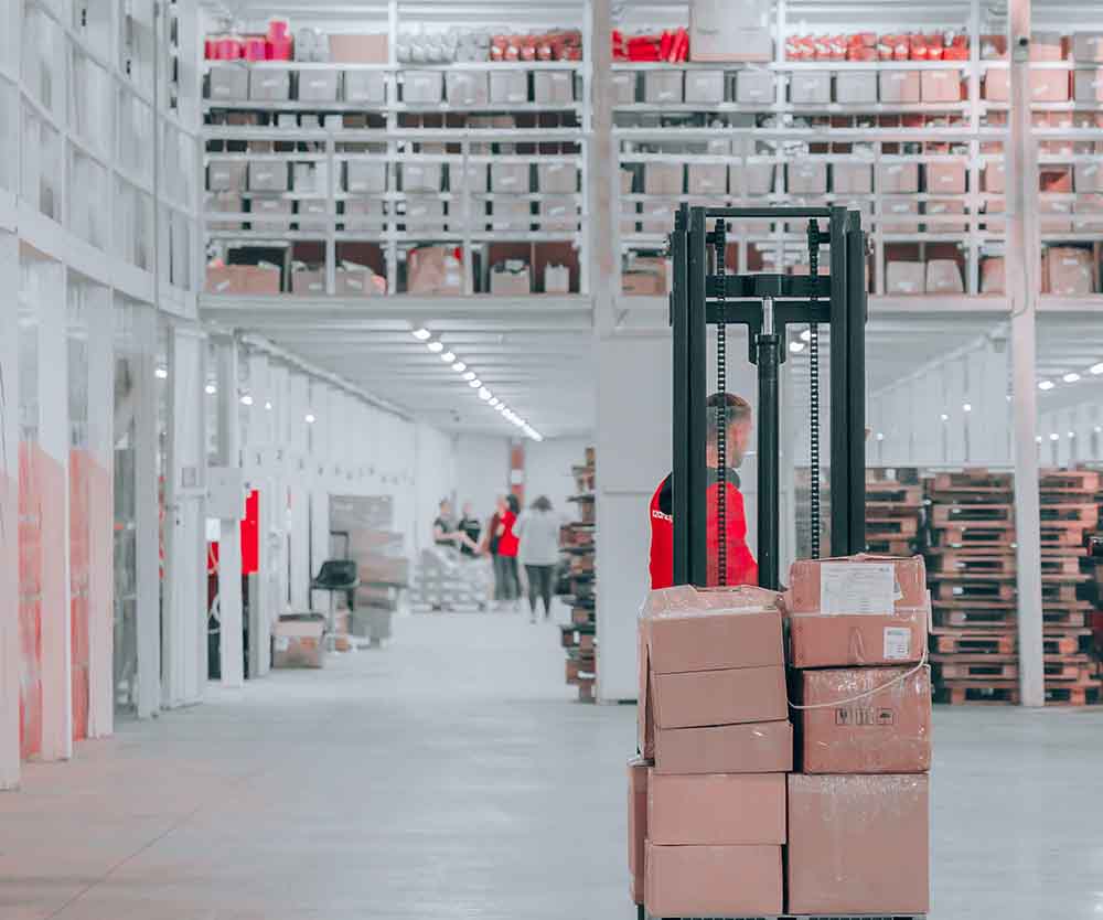 a person in a warehouse with boxes