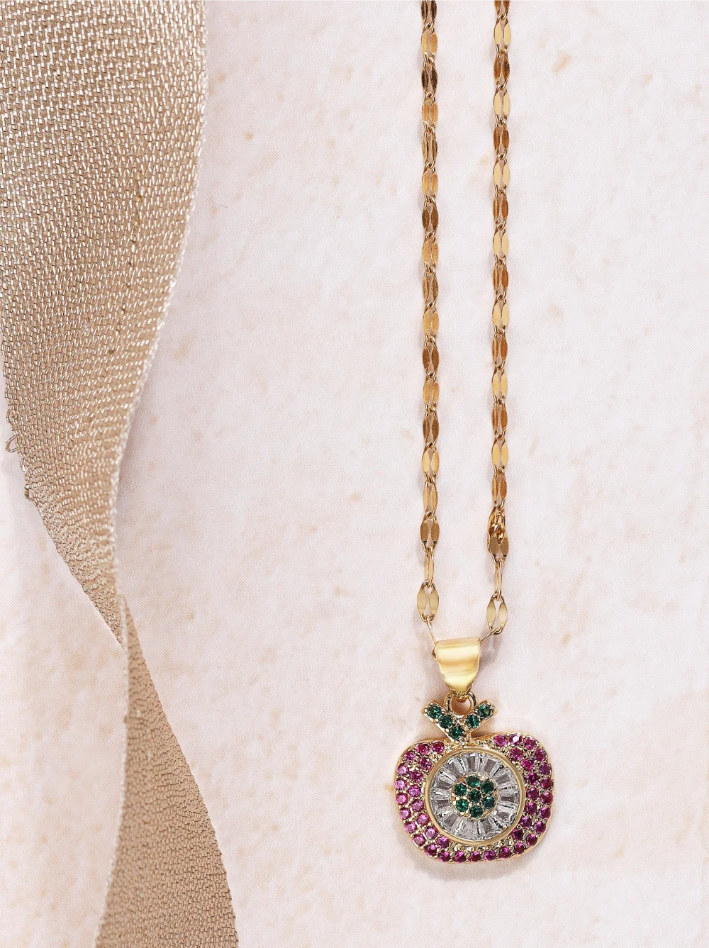 a gold chain with a heart shaped pendant