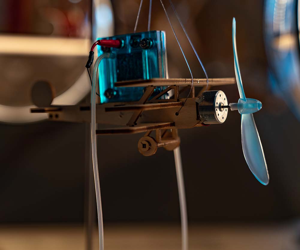 a small airplane with a propeller and wires