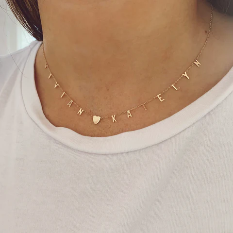 a person wearing a necklace with name necklaces