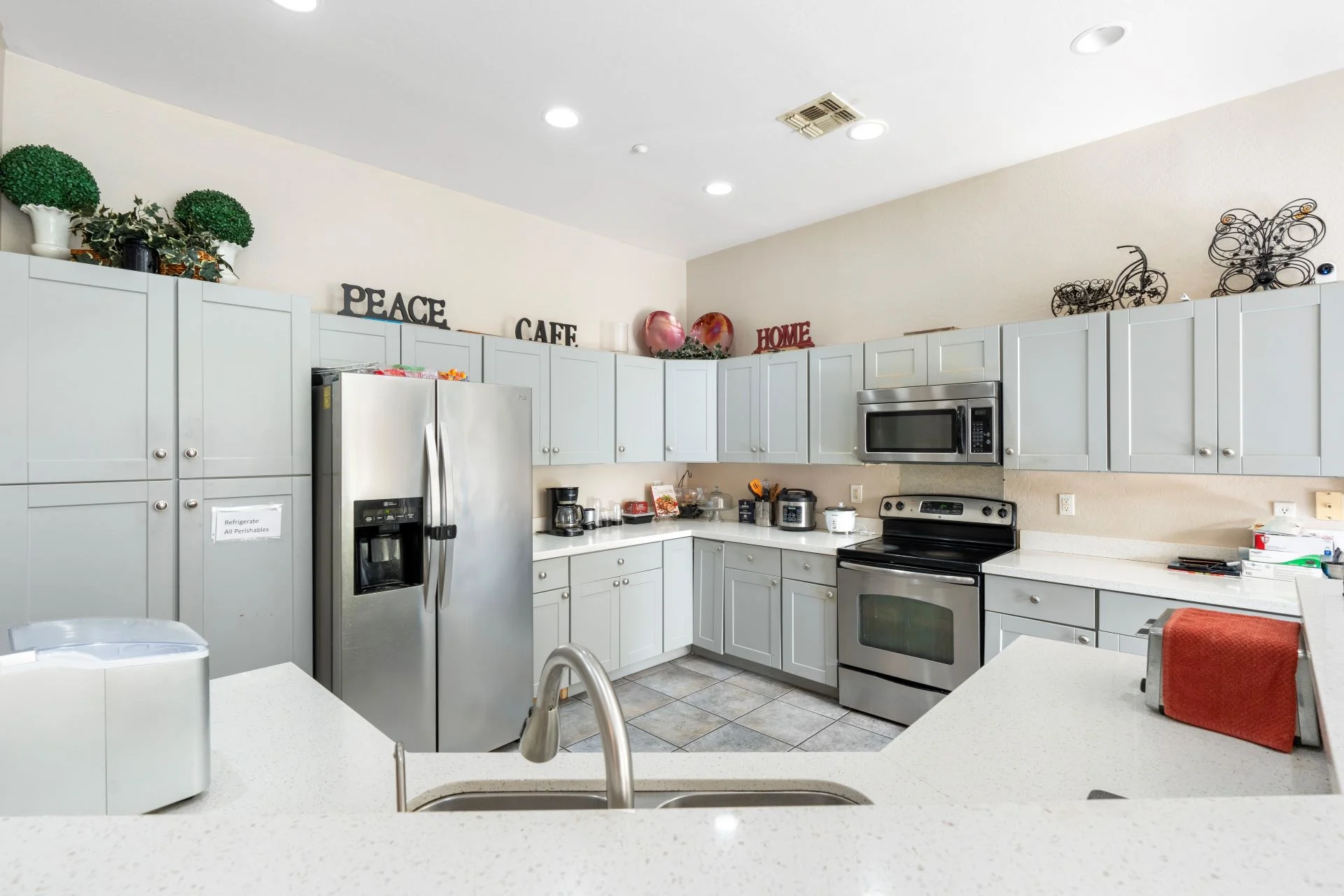 a kitchen with white cabinets and appliances