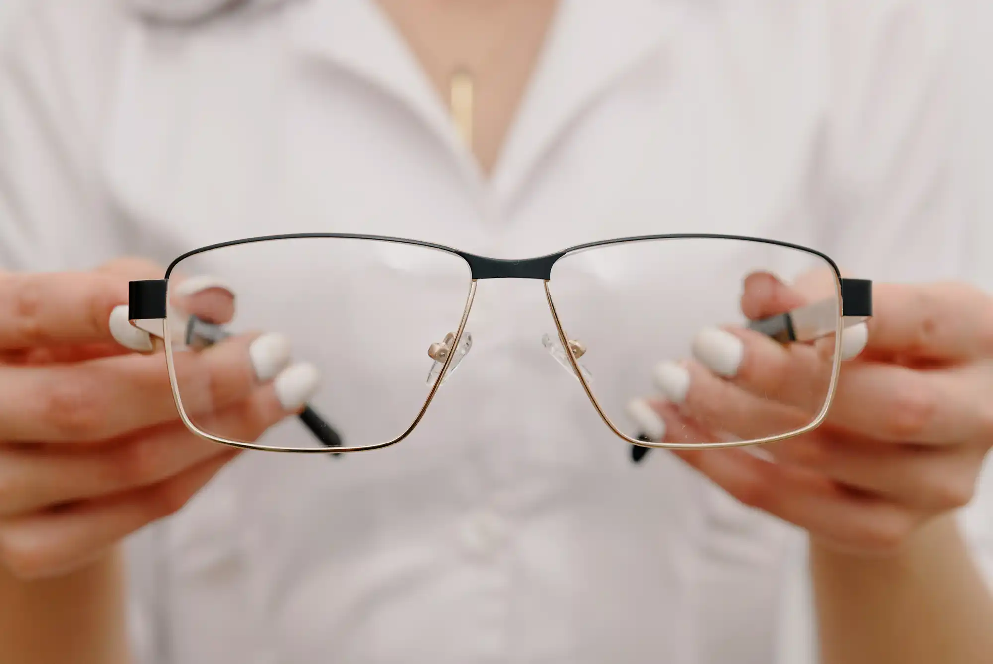 a person holding glasses in their hands