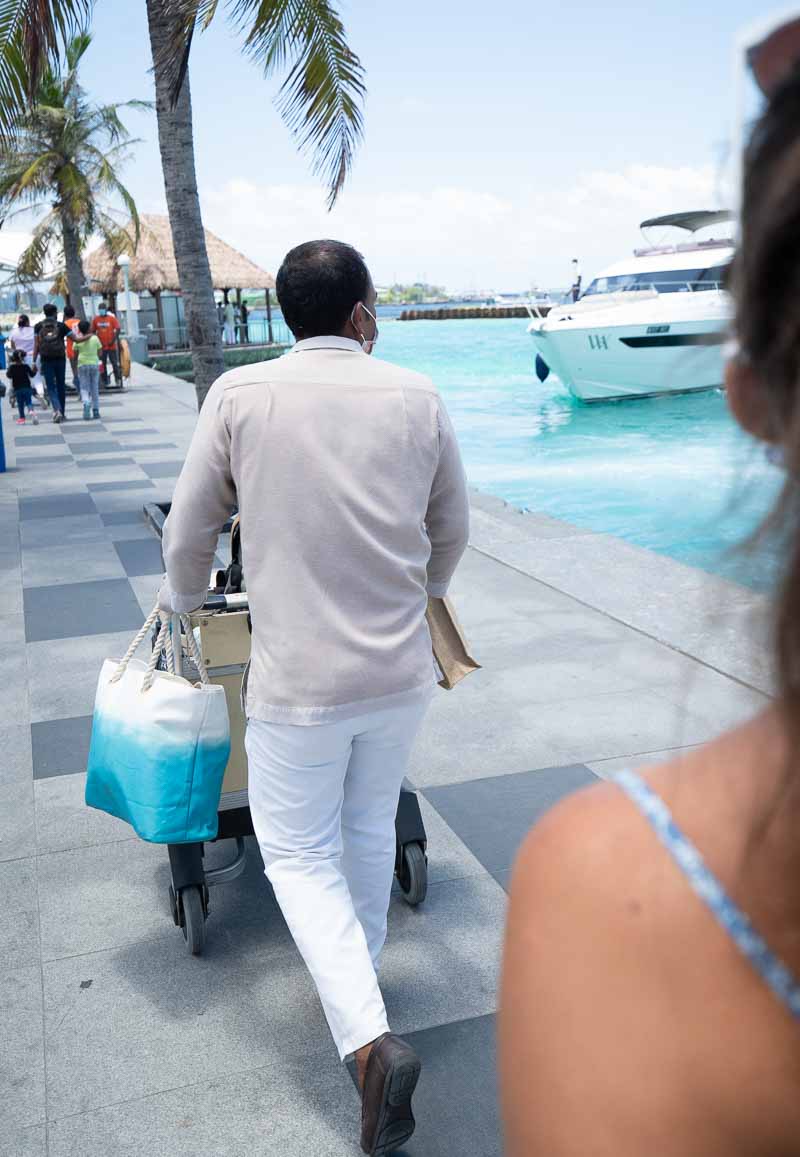 a man pushing a cart with a bag
