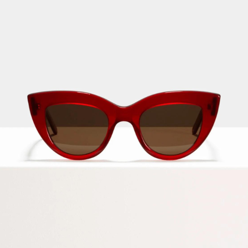 a red sunglasses on a white surface