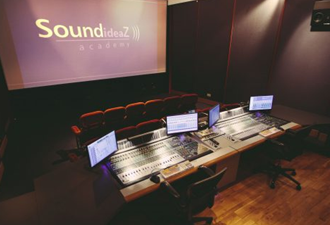 a room with several monitors and a projector screen