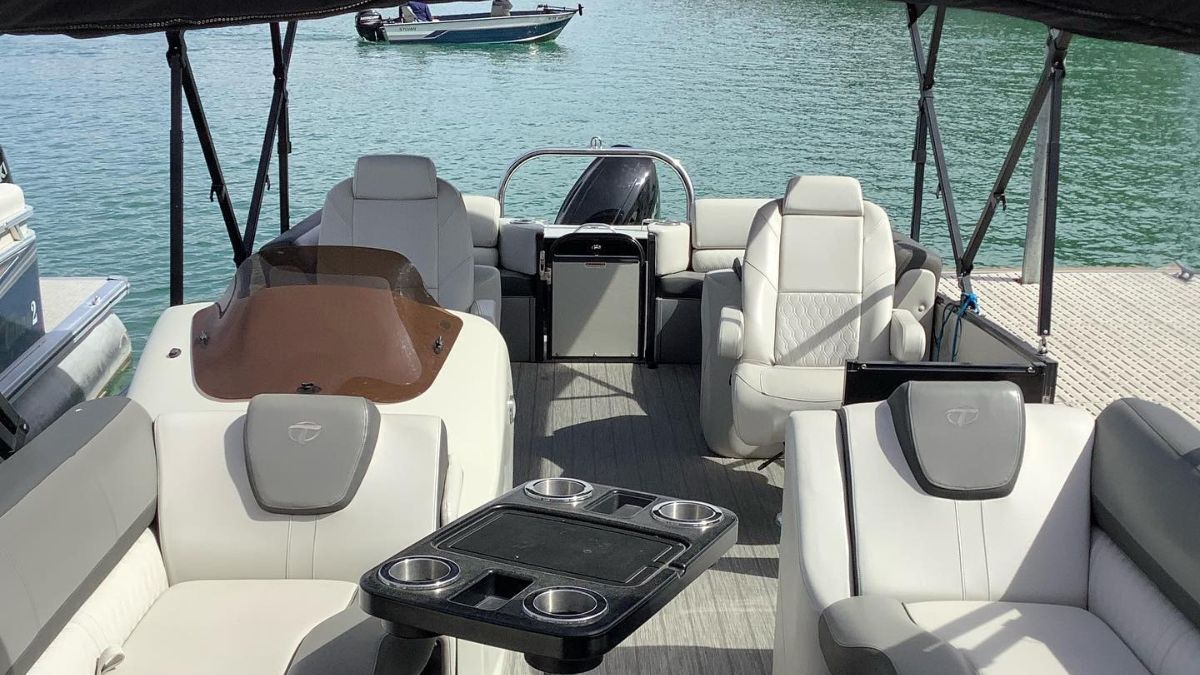 a boat with seats and a table on the water
