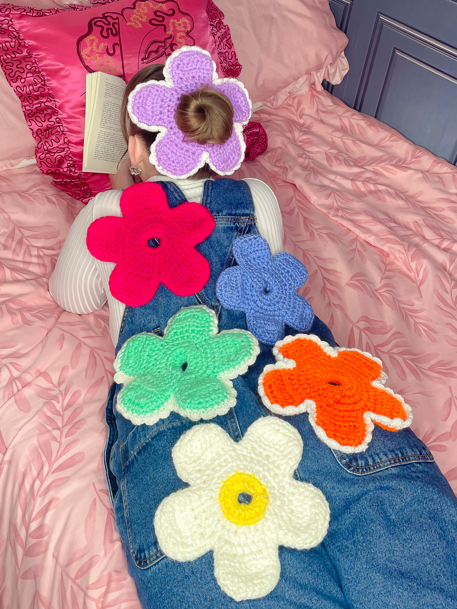 a person lying on a bed with flowers on their back