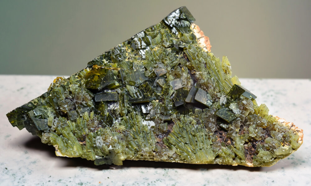 a green rock with crystals
