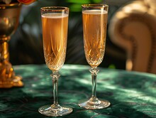 two glasses of champagne on a table