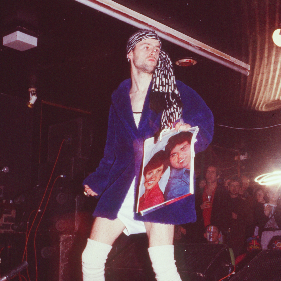 a man wearing a blue robe and a scarf holding a picture