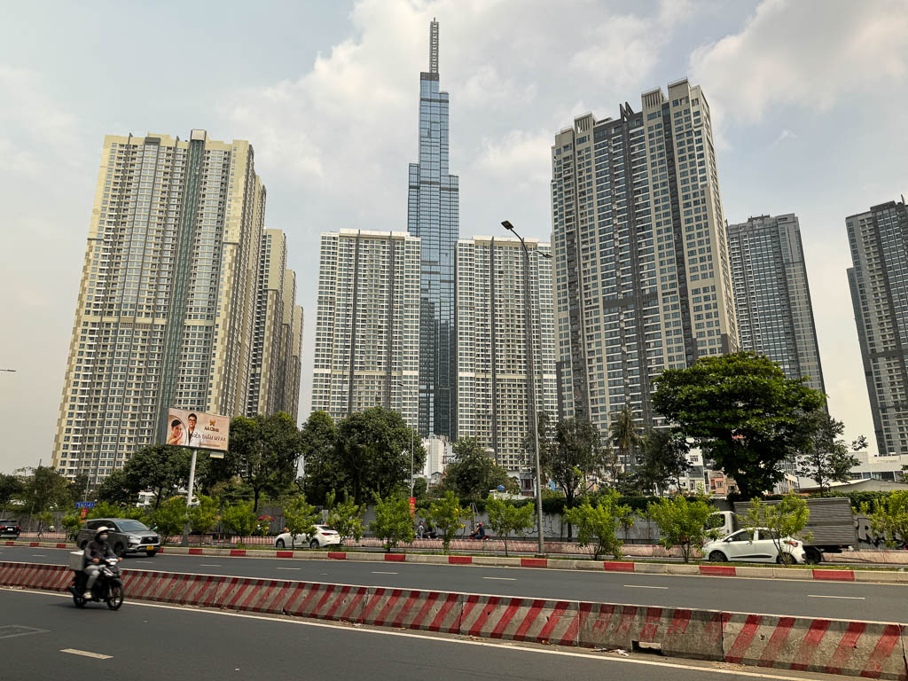 a street with a tall building in the background
