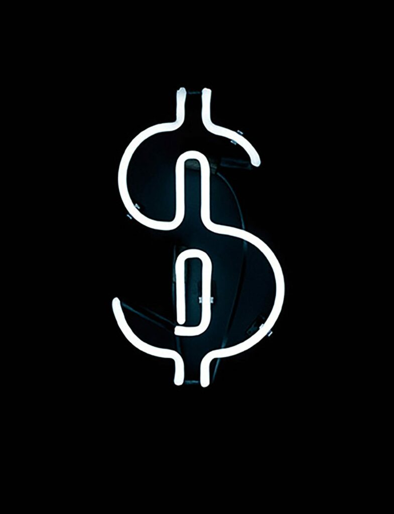 a neon dollar sign on a black background