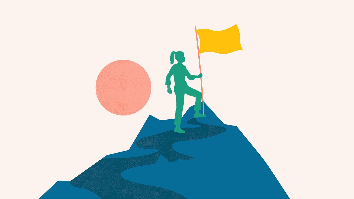 a girl holding a flag on a mountain