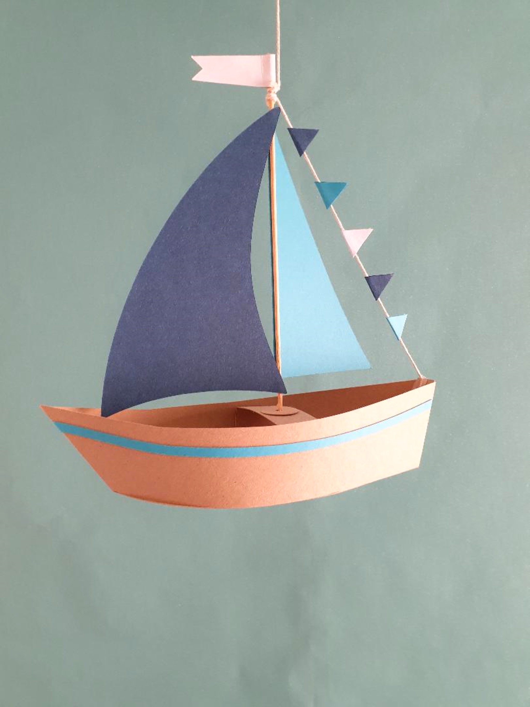 a paper boat with a sail