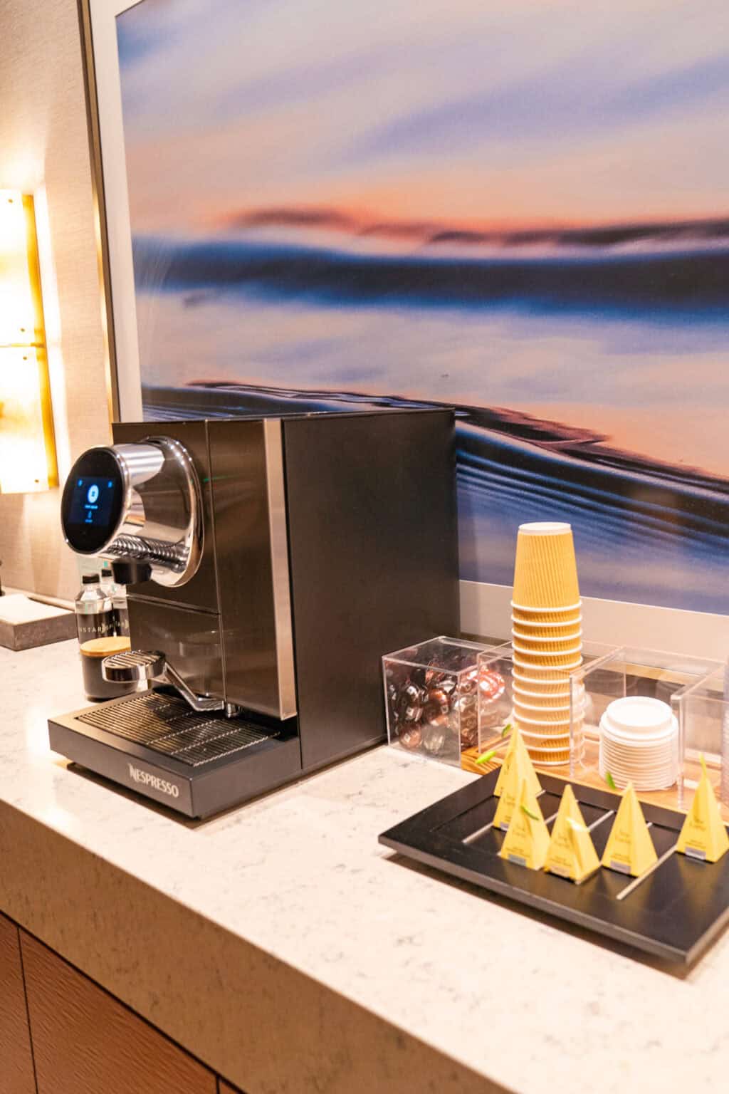 a coffee machine and cups on a counter