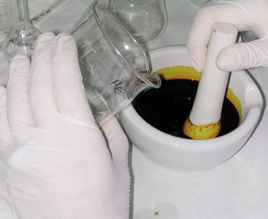 a person pouring liquid into a mortar