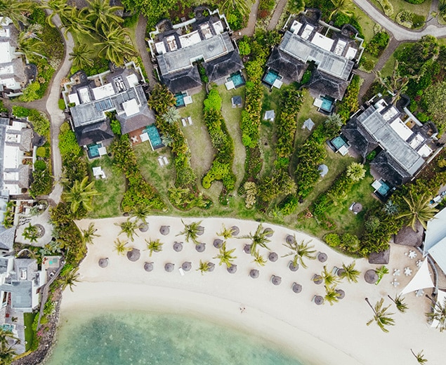 aerial view of a beach with houses and palm trees