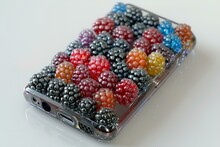 a cell phone with a case full of berries