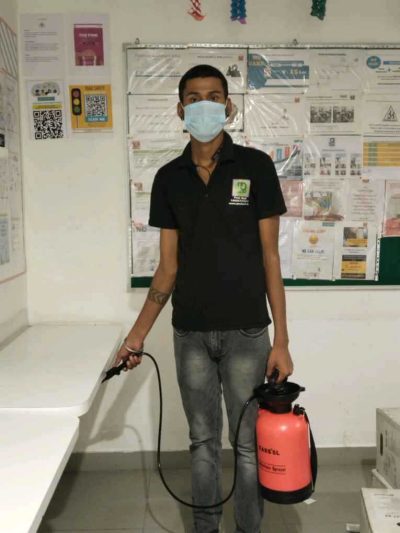 a man wearing a mask and holding a fire extinguisher