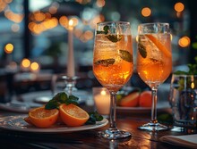 a group of glasses with oranges on a table