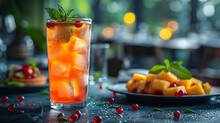 a glass of ice tea with a plate of fruit