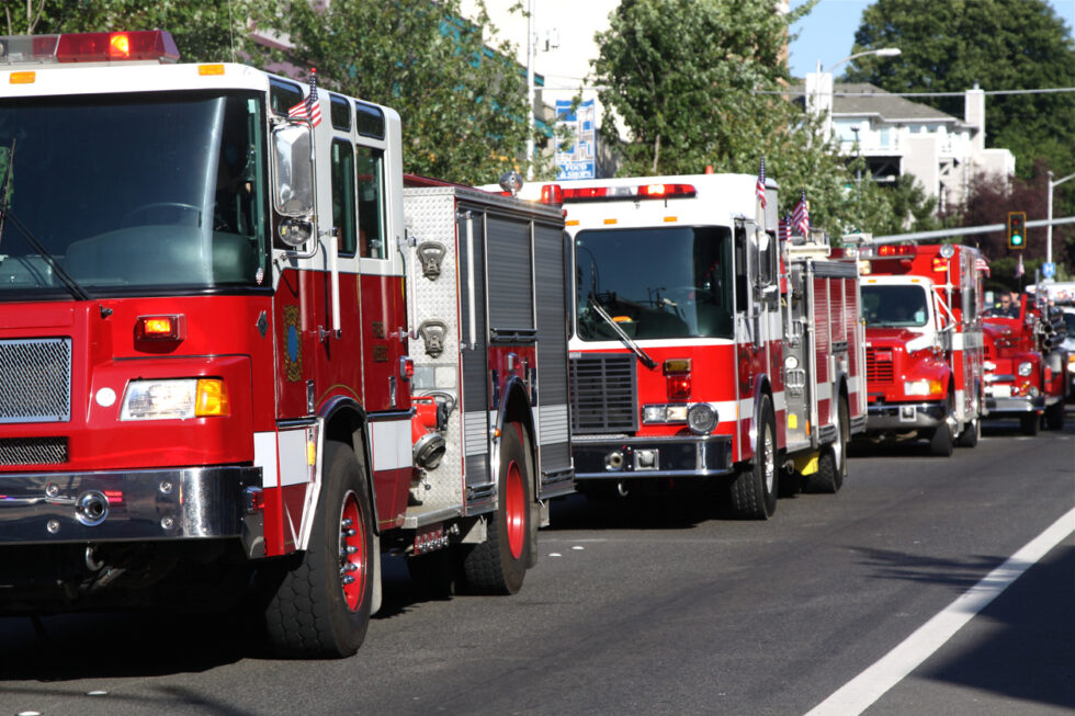 a row of fire trucks on a street