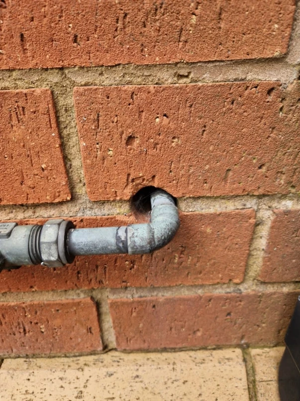 a pipe in a brick wall