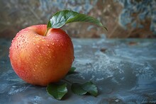 a red apple with green leaves