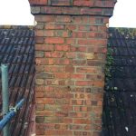 a brick chimney on a roof