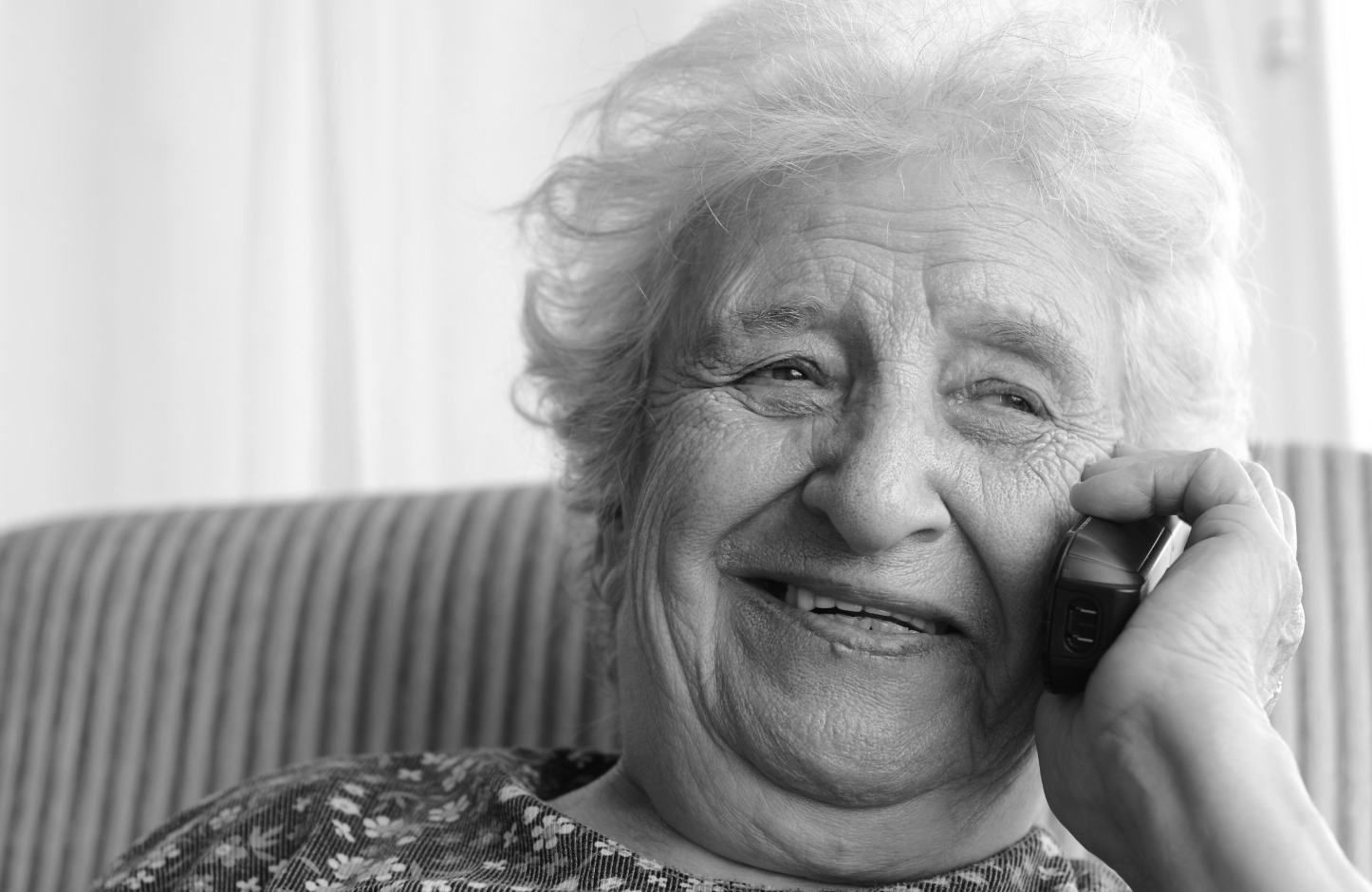 an old woman talking on a cell phone