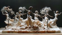 a group of statues of women dancing