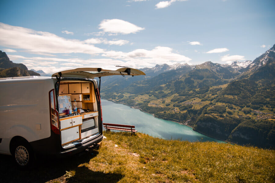 a van on a hill overlooking a river