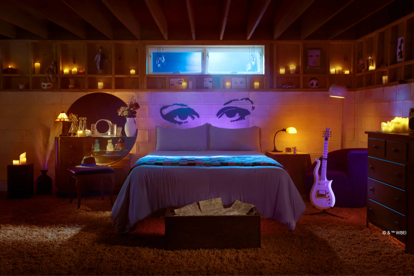 a bedroom with a bed and a guitar