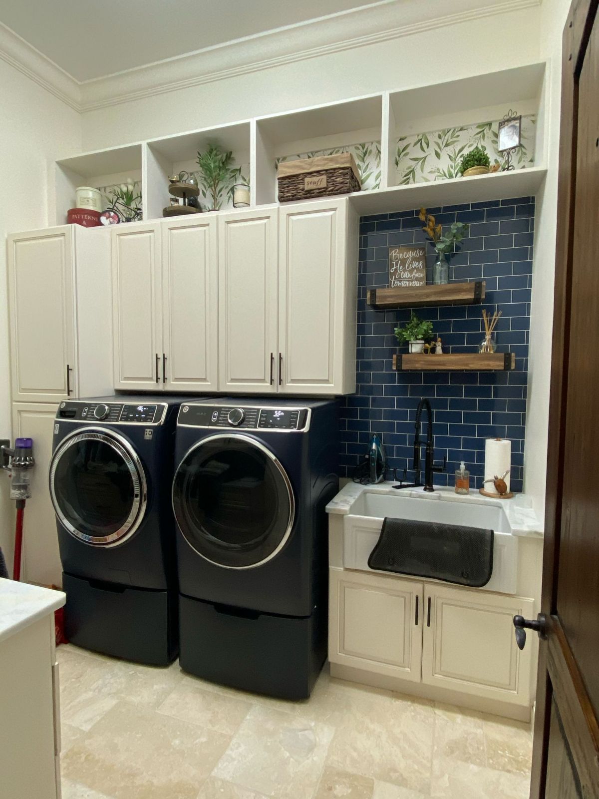 a laundry room with white cabinets and washer and dryer