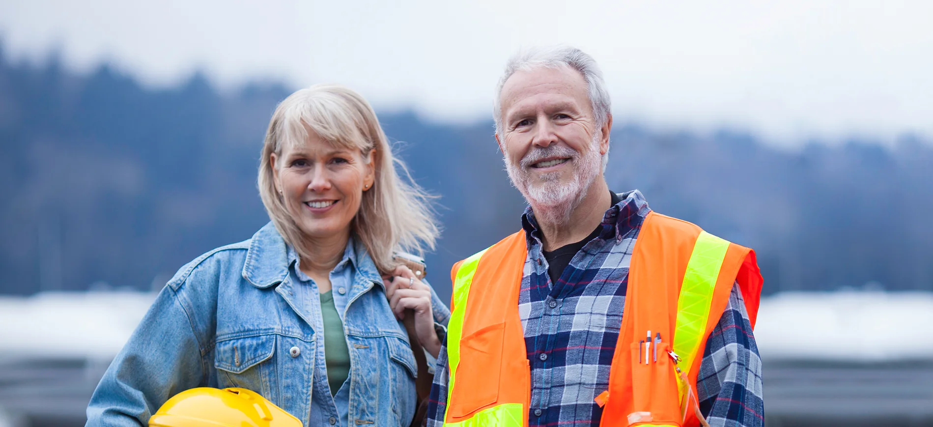 a man and woman in safety vests